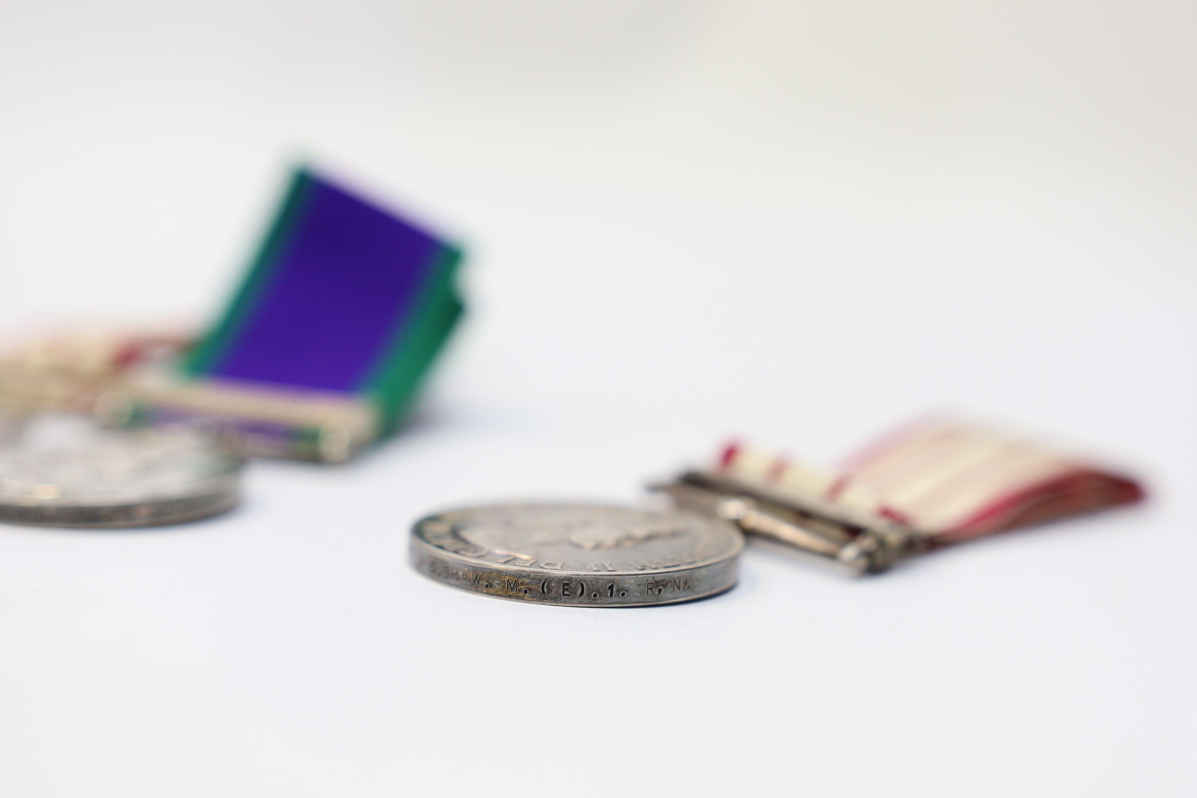 Three ERII Royal Navy medals; a Campaign Service Medal with a bar for Radfan awarded to J. Rush R.E.A.2 R.N., A Naval General Service Medal with a bar for the near East awarded to P/SKX J-C. Shaw M.(E.)1. R.N., plus a se